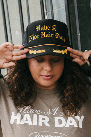 Have A Nice Hair Day Black and Gold Emblem Trucker Hat